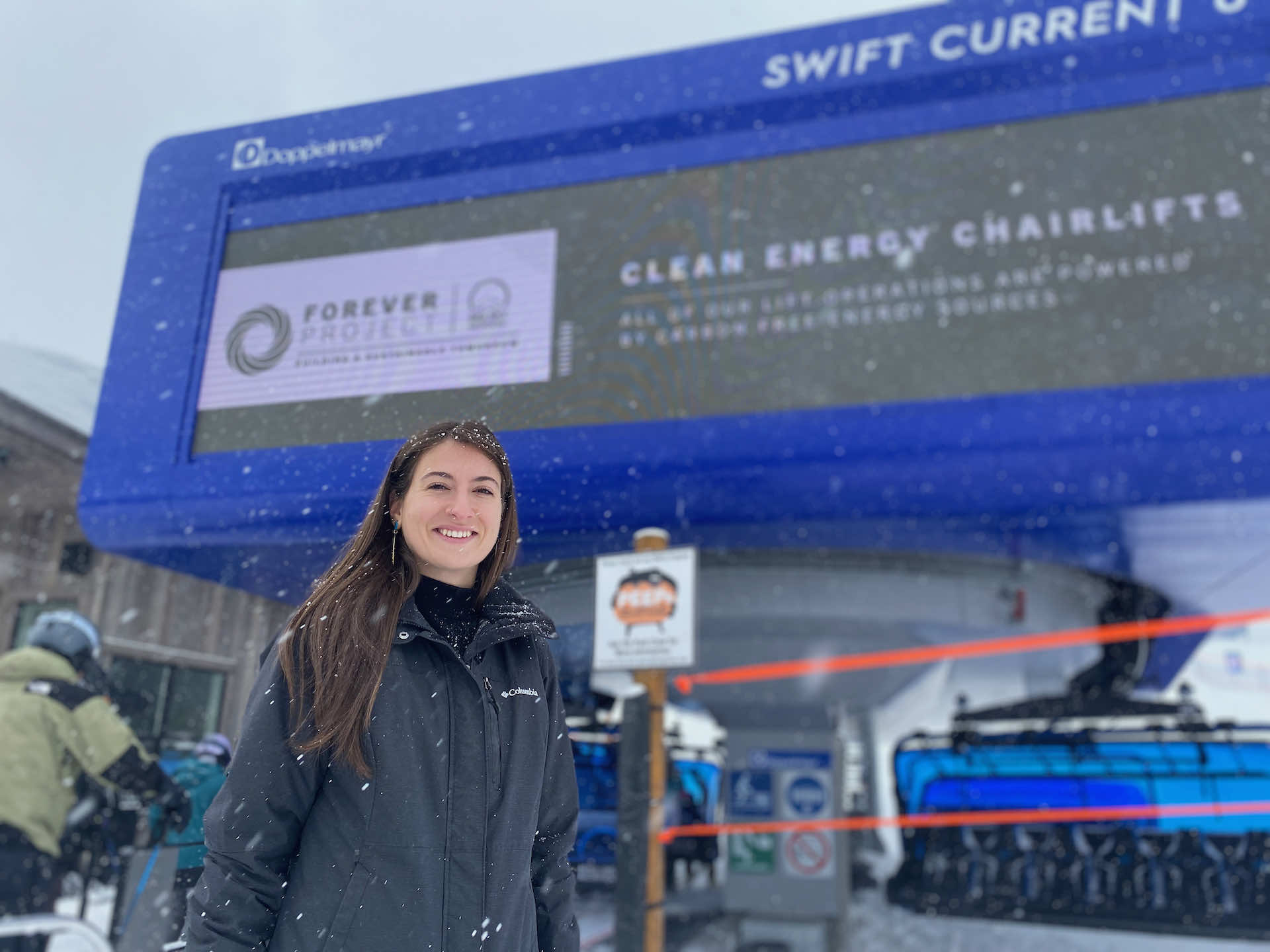 Amy stands in front of Swift Current 6