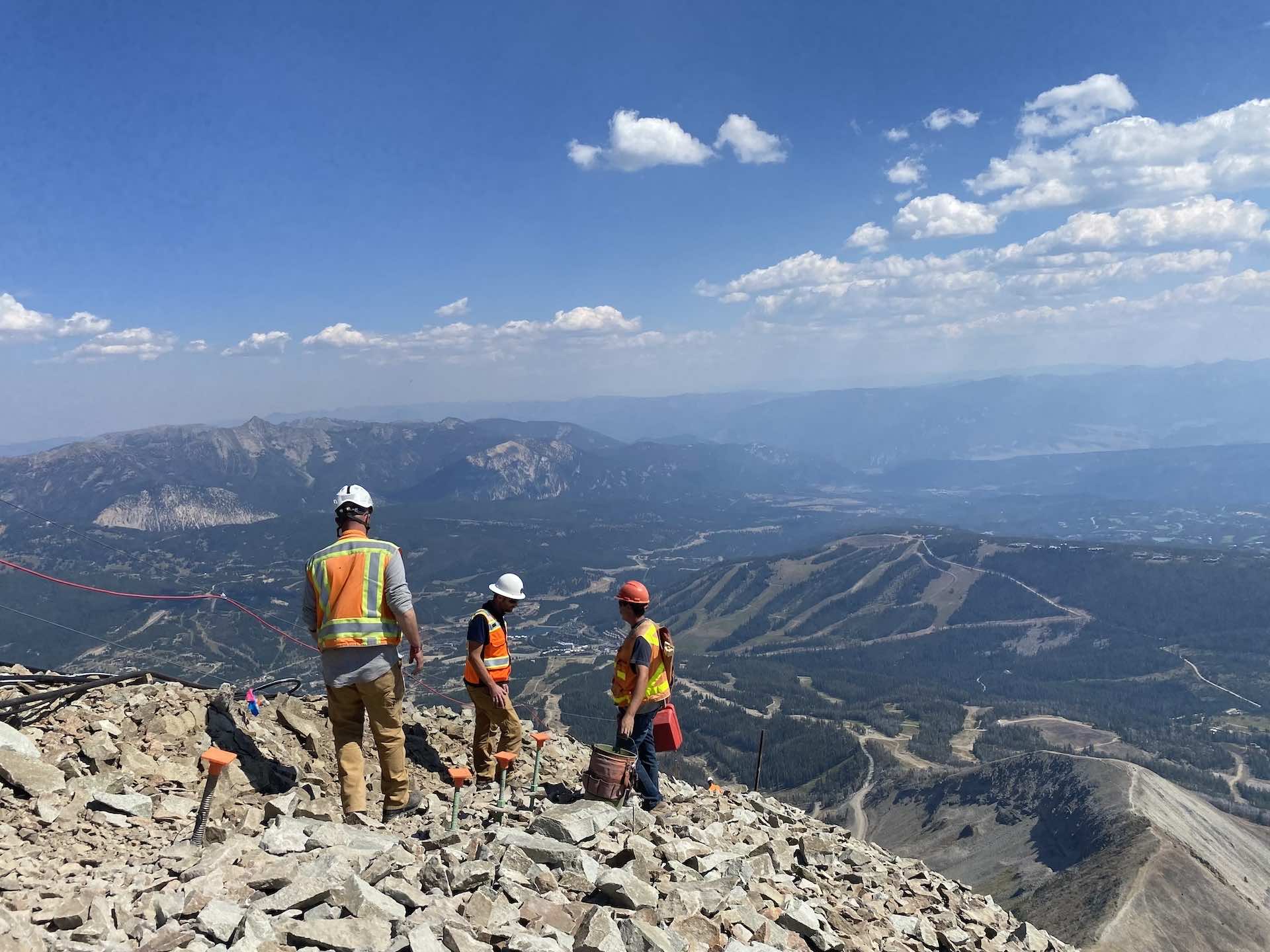 Men in construction gear at the top of Lone Peak