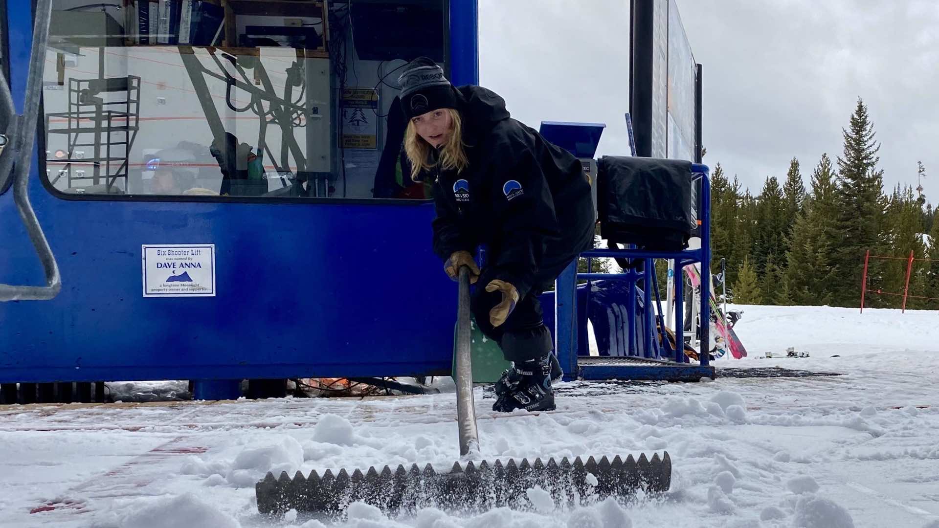 Woman raking snow
