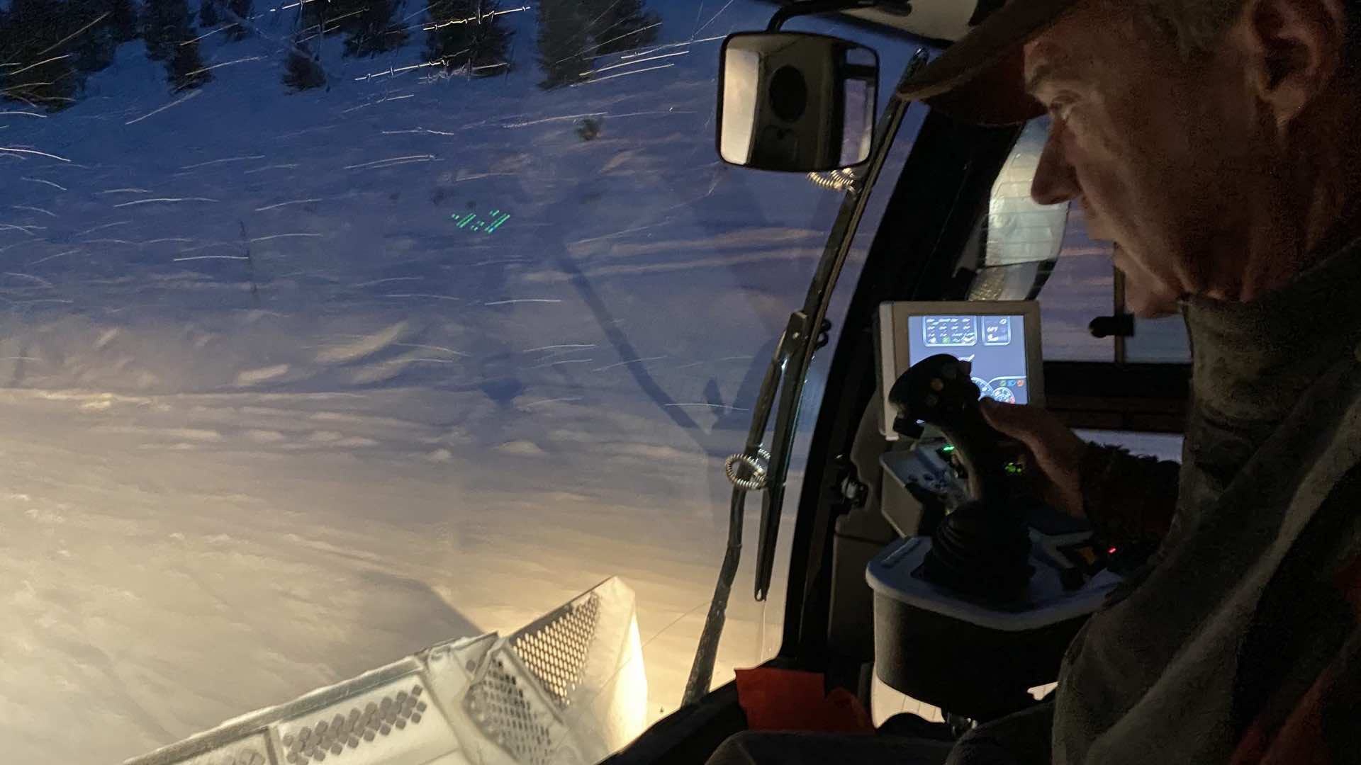 View from the inside of a snowcat at night