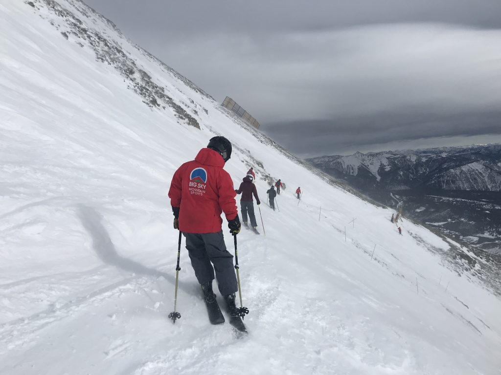 Skiers traversing a run