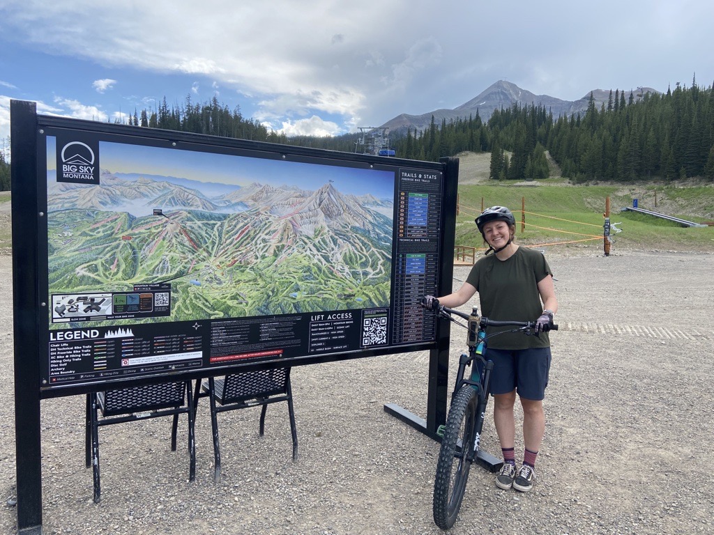 Siberell standing next to the trail map at Big Sky Resort